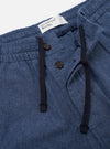 The Blue Sintra Recycled Cotton Oxford Pant is shown from the back as a flat lay against a plain white background. The image highlights the two rear patch pockets and the elasticated waistband with a drawstring. The light blue fabric has a visible textured weave.