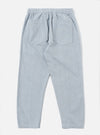 The Light Indigo Jean Cloth Reworked Hi Water Trouser is shown from the back as a flat lay against a plain white background. The image highlights the two rear patch pockets and the elasticated waistband of the light blue organic cotton trousers. The cropped, slim-fit design is visible with clean stitching details along the seams and hem.