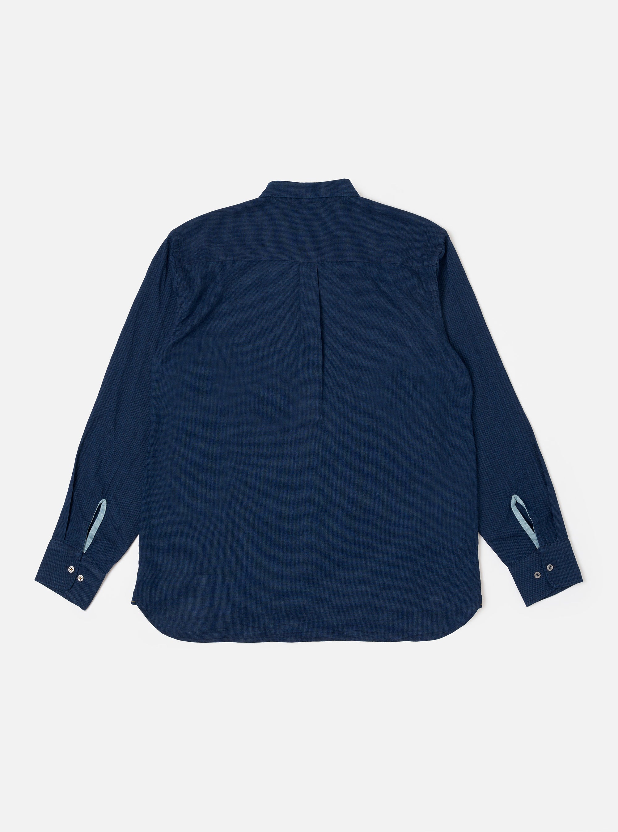 The Indigo Lincot Denim Lazy Day Shirt is shown from the back as a flat lay against a plain white background. The image highlights the shirt's relaxed fit, a back yoke with a central box pleat, and the subtle texture of the indigo-dyed linen and cotton blend fabric.
