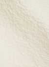 A close-up fabric swatch of the Ecru Arten Seersucker Attendant Shirt highlights the off-white color and the distinct puckered texture of the organic cotton seersucker fabric.