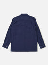 The Navy Arten Seersucker Attendant Shirt is shown from the back as a flat lay against a plain white background. The image highlights the shirt's clean, straight hem and simple back panel construction. The dark navy organic cotton fabric features a distinct and visible puckered seersucker texture throughout.