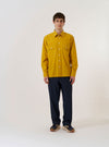 The Golden Brown Organic Fine Poplin CPO Shirt is shown as a flat lay against a white background. The shirt features two large chest patch pockets with buttoned flaps, a central button-down front, and a structured collar. The fine organic cotton poplin fabric has a smooth, golden brown finish.