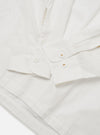 The Ecru Organic Fine Poplin CPO Shirt is shown from the back as a flat lay against a plain white background. The image highlights the garment's relaxed loose fit, straight hem, and the clean construction of the two-piece collar and rear yoke. The fabric is a solid ecru organic cotton poplin with a smooth, lightweight finish.