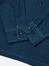 The Navy Organic Fine Poplin CPO Shirt is shown from the back as a flat lay against a plain white background. The image highlights the clean lines of the organic cotton poplin fabric, featuring a two-piece collar, a straight hem, and functional cuffs.