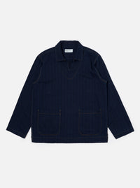 The Indigo Recycled Herringbone Smock Overshirt is shown as a flat lay against a plain white background. The overshirt features a partial button-down placket, a large chest patch pocket on the left side, and a simple collar. The dark indigo fabric has a visible herringbone weave texture.