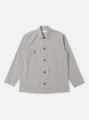 The Grey Izumi Cotton Dockside is shown as a flat lay against a plain white background. The overshirt features a classic collar, a central button-down front, and two large patch pockets at the waist. The grey cotton fabric has a fine, textured appearance.