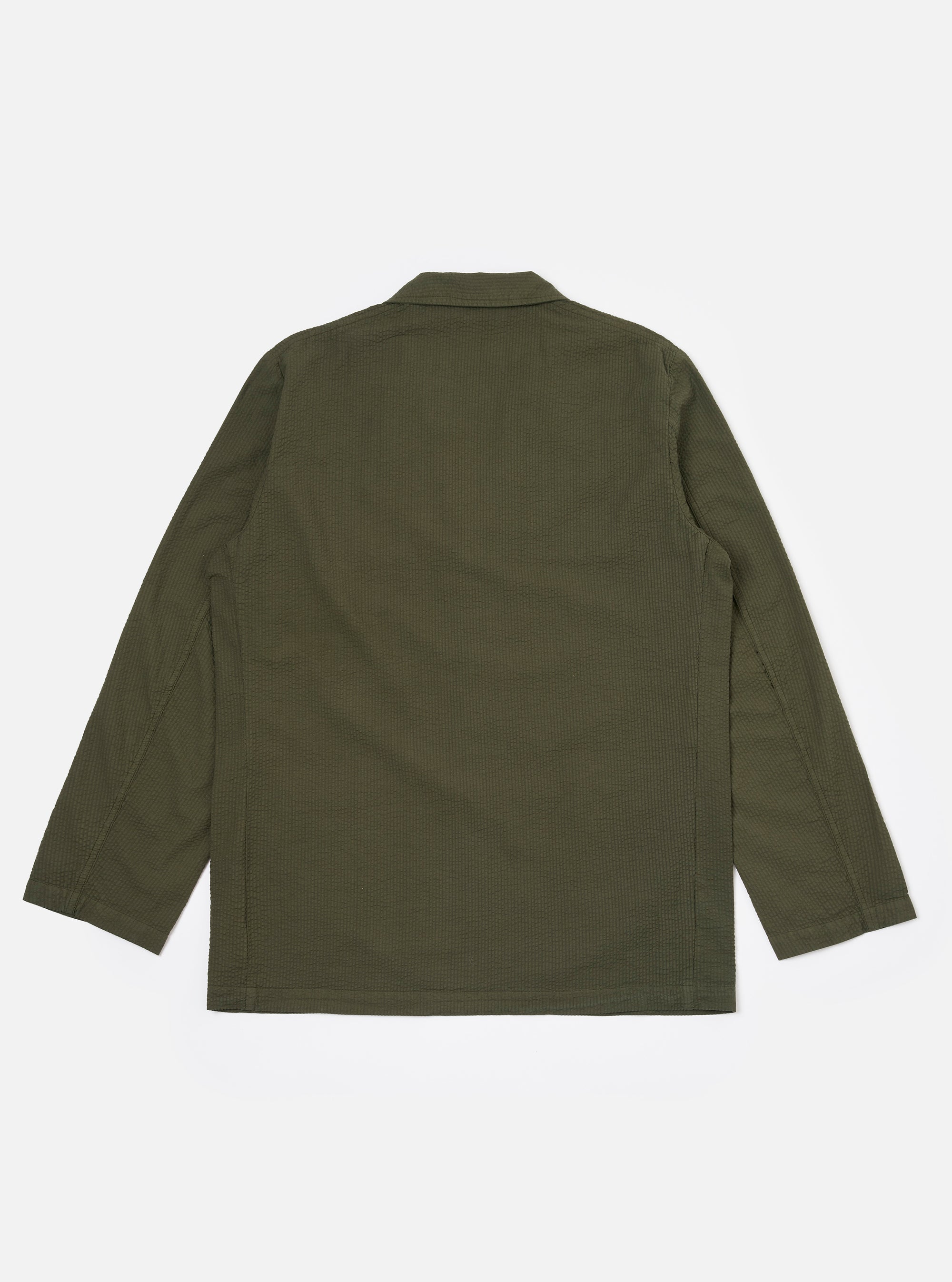 The Olive Merida Seersucker Three Button Jacket is shown as a flat lay against a white background. The jacket features a three-button front closure, a notched lapel, two large lower patch pockets, and one chest patch pocket. The olive green fabric has a distinct puckered seersucker texture throughout.