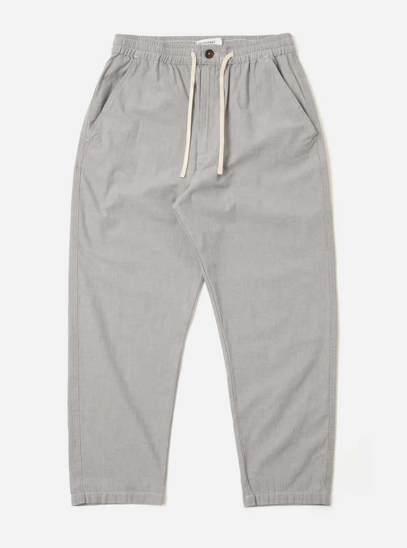 The Grey Izumi Cotton Hi Water Trouser is shown as a flat lay against a white background. The trousers feature a relaxed fit, a cropped length, and a drawstring waist with a visible white cord. The grey cotton fabric has a subtle, textured appearance.
