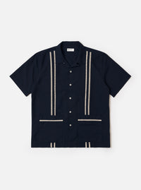 The Navy Classic Oxford Tropicana Shirt is shown as a flat lay against a plain white background. The shirt features a one-piece collar, a five-button front closure, and short, loose sleeves. Two large patch pockets are prominent on the lower front, and tonal inset embroidery detail is visible. The hem includes side splits and is longer at the back.