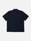 The Navy Classic Oxford Tropicana Shirt is shown from the back as a flat lay against a white background. The image highlights the relaxed fit, one-piece collar, and short, loose sleeves. The hem is slightly curved and longer at the back with small side splits.