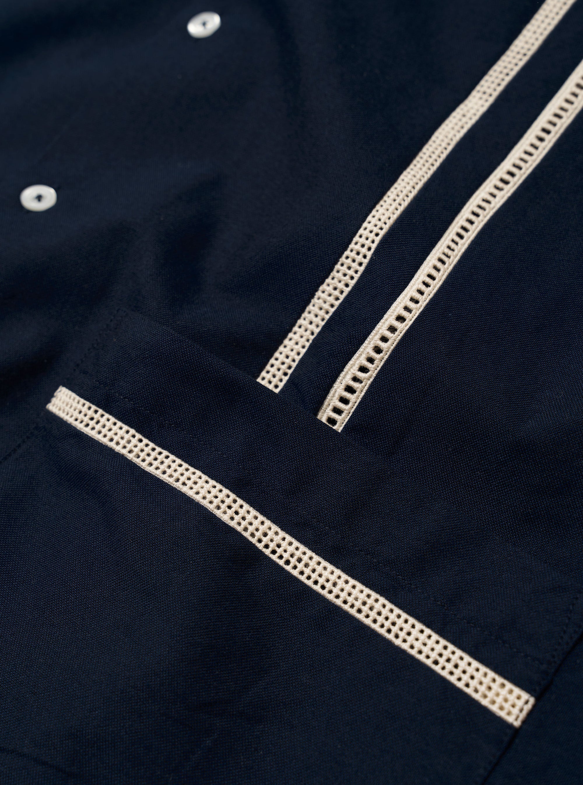 The Navy Classic Oxford Tropicana Shirt is shown from the back as a flat lay against a white background. The image highlights the one-piece collar, a straight back yoke, and a side split hem that is longer at the back. The navy blue Oxford cotton fabric has a visible textured weave.