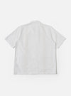 The White Classic Oxford Tropicana Shirt is shown as a flat lay against a white background. The shirt features an open convertible collar, a full-length button placket with five buttons, and two large chest patch pockets. It has short raglan sleeves and a straight hem with small side slits. The fabric is a crisp white Oxford cotton.