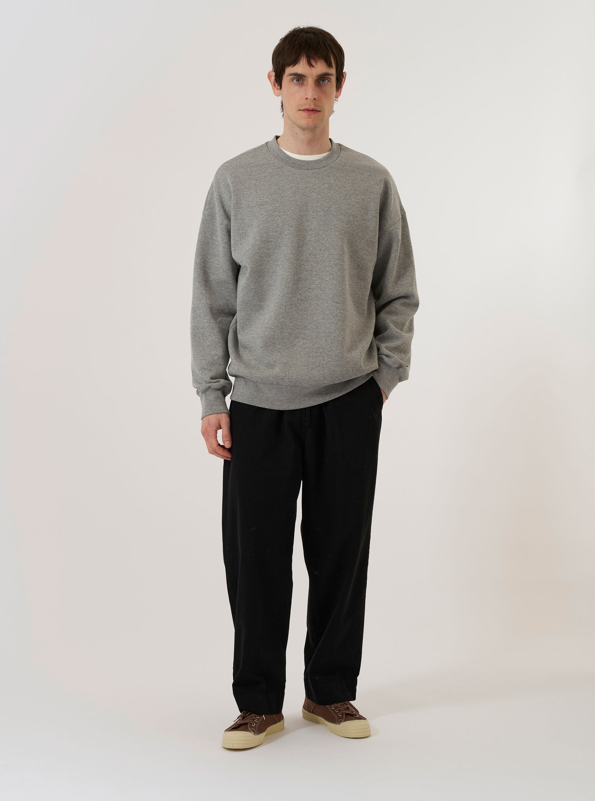 The Grey Marl Recycled Cotton Blend Jersey Loose Sweatshirt is shown as a flat lay against a plain white background. The sweatshirt features a crew neckline, long sleeves, and ribbed detailing on the collar, cuffs, and hem. The fabric has a classic grey marl texture.