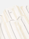 The Ecru/Navy/Sand Hendrix Stripe Road Shirt is shown from the back as a flat lay against a plain white background. The image highlights the vertical stripe pattern in ecru, navy, and sand, as well as the straight hem and simple back yoke construction.
