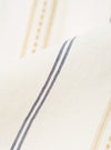 A close-up fabric swatch of the Ecru/Navy/Sand Hendrix Stripe Road Shirt shows the vertical stripe pattern in shades of cream, dark navy, and tan. The cotton fabric has a visible weave and the textured stripes run parallel to each other.