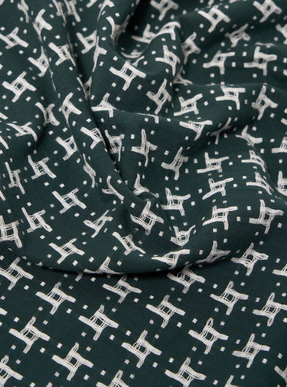The Green/White Rhodes 8 Cotton Road Shirt is displayed as a flat lay against a plain white background. The shirt features a prominent green and white checkered pattern and is designed with a relaxed camp collar and short sleeves. It has a central button-down front and a single patch pocket on the left chest. The fabric appears lightweight with a textured cotton finish.