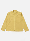 The Yellow Mykonos Cotton Zip Shirt is shown as a flat lay against a white background. The shirt features a full-length central silver zipper, a classic structured collar, and two large patch pockets at the waist. The cotton fabric is a vibrant yellow with a subtle, fine-textured weave.