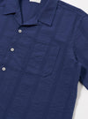 The Blue Maui Cotton Road Shirt is displayed as a flat lay against a white background. The shirt features a blue and navy striped pattern on cotton fabric, a relaxed camp collar, and a straight hem.