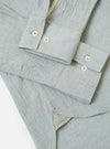 The Green Seersucker Square Pocket Shirt is shown from the back as a flat lay against a plain white background. The image highlights the straight hem, a simple back yoke, and the distinct puckered texture of the green seersucker fabric.