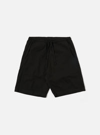 The Black Kelly Cotton Simple Short is shown as a flat lay against a white background. The shorts feature an elasticated waistband with a drawstring, two slanted side pockets, and a single rear patch pocket. The fabric is a solid black cotton with a slight texture.