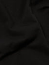 A close-up fabric swatch of the Black Kelly Cotton Simple Short highlights the solid black color and the smooth, fine texture of the cotton material. The fabric fills the frame, providing a detailed view of the weave and finish.