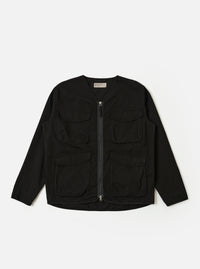 The Black Kelly Cotton Glider Jacket is shown as a flat lay against a white background. The jacket features two large chest pockets with buttoned flaps, a central button-down front, and a classic pointed collar. The fabric is a solid black cotton with visible stitching details.