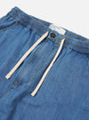 The Washed Indigo 8oz Slub Denim Hi Water Trouser is shown from the back as a flat lay against a plain white background. The image highlights the two rear patch pockets, the elasticated drawstring waistband, and the textured, washed indigo denim fabric.