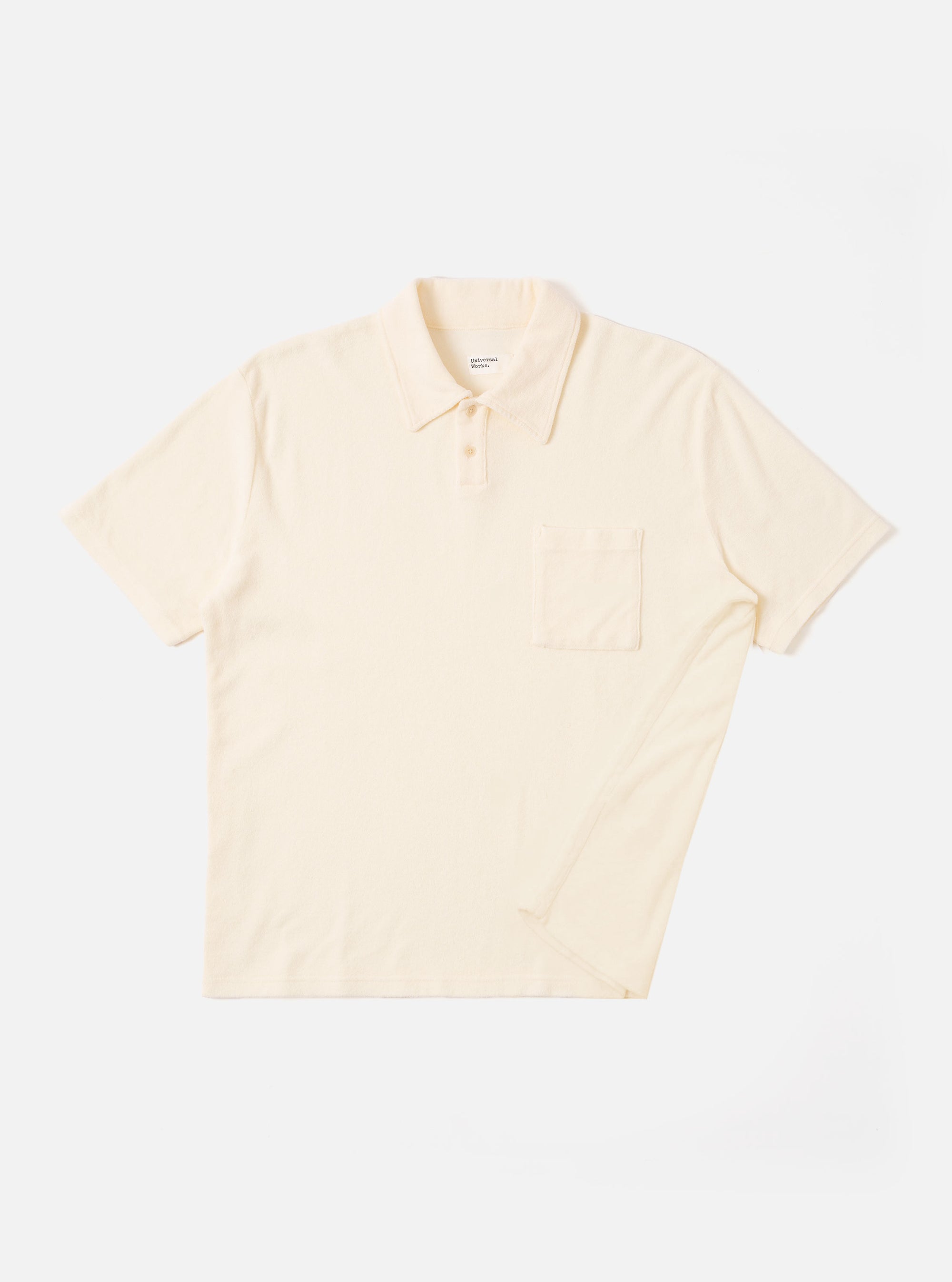 The Ecru Light Weight Terry Newlyn Polo is shown as a flat lay against a white background. The shirt features a polo collar, a three-button front closure, and a single patch pocket on the left chest. The garment is made from a light-colored terry fabric with a soft, fluffy texture.