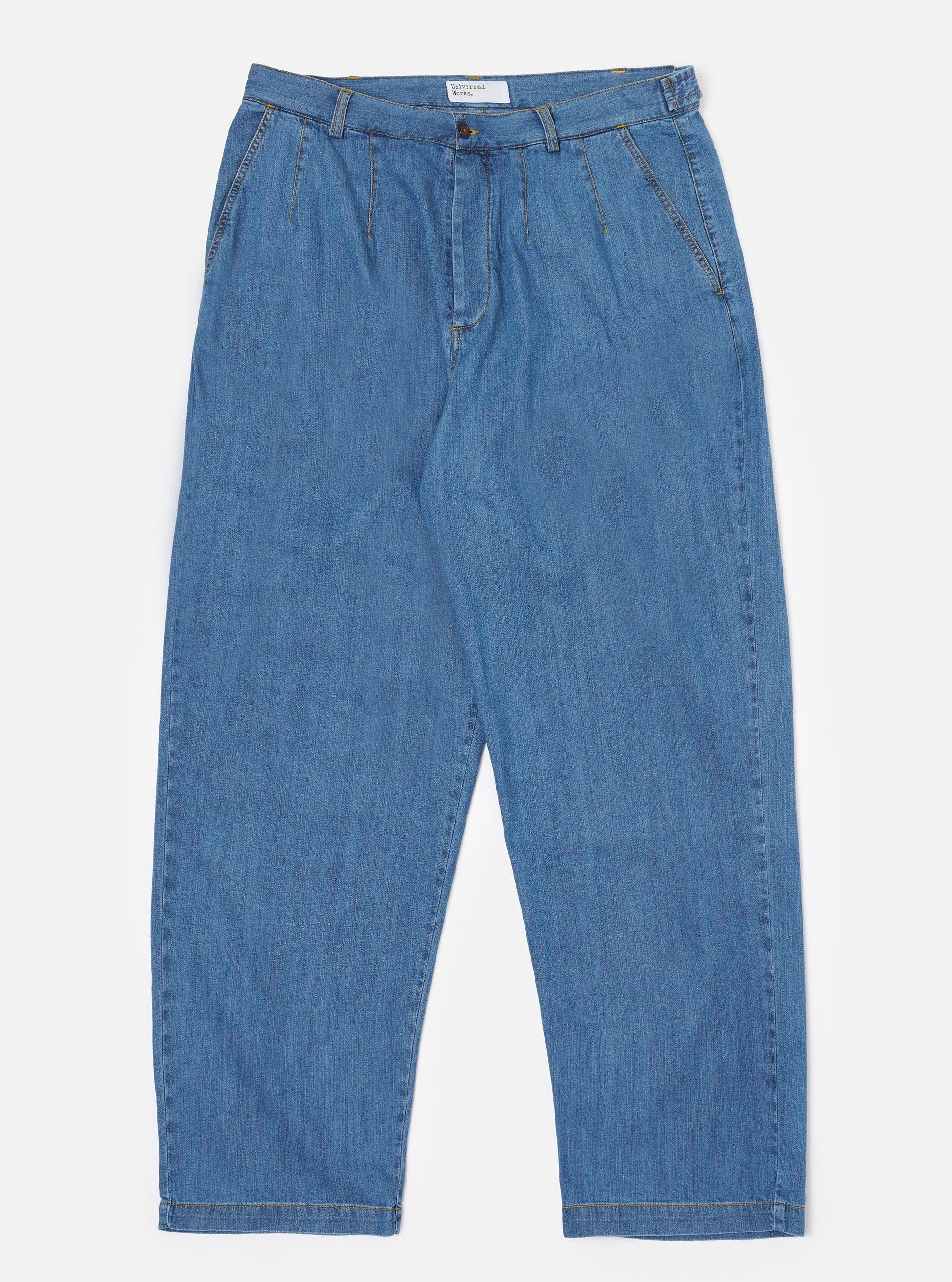 The Washed Indigo 8oz Slub Denim Dutch Pant is shown as a flat lay against a white background. The trousers feature a wide-leg silhouette, an elasticated waistband with side button adjusters, and a button fly. The 8oz slub denim fabric has a visible textured grain in a washed indigo blue.