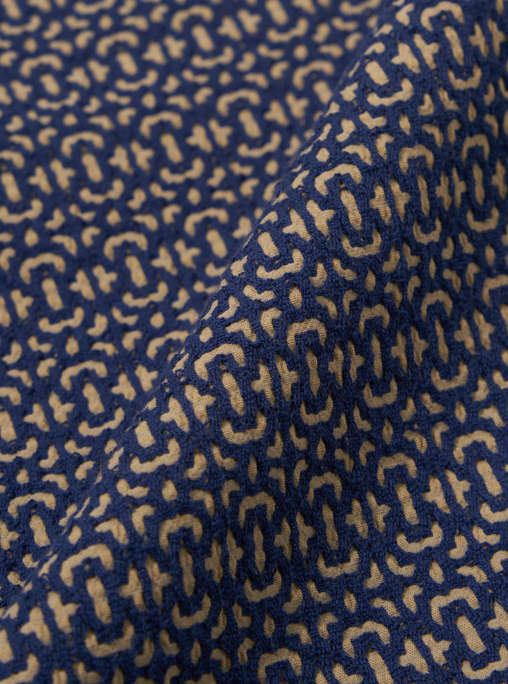 A close-up fabric swatch of the Navy Konos Cotton Judo Pant highlights the textured weave and deep navy blue color of the cotton material. The fabric fills the frame, providing a detailed view of the garment's construction and pattern.