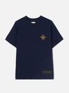Front view of the Walsh x Universal Works Navy Single Jersey T Shirt laid out flat against a plain light background. Prominent features include the classic crew neck, chest print detailing, short sleeves, and rich navy jersey fabric.