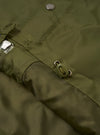 Back view of the Walsh x Universal Works Olive Flight Nylon Club Coach Jacket shown against a clean white backdrop. The design highlights a straight hemline, neat shoulder seams, and smooth olive green flight nylon material.