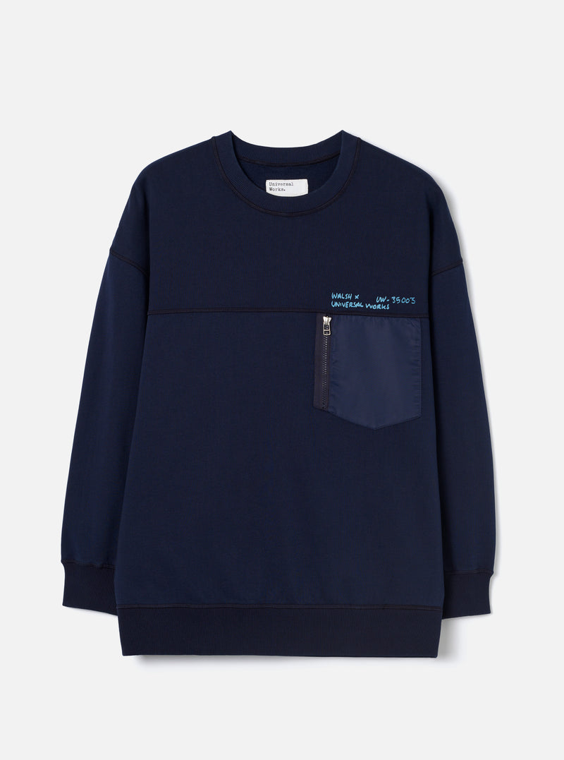Front view of the Walsh x Universal Works Navy Brushback Sweat Panelled Loose Sweatshirt on a white studio background. Features include a classic crewneck collar, deep navy cotton fleece body, panelled seams, and stretchy ribbed hem.