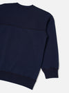 Rear view of the Walsh x Universal Works Navy Brushback Sweat Panelled Loose Sweatshirt presented on a clean white background. The shot highlights the smooth back paneling, drop-shoulder seams, and soft navy blue brushback cotton.