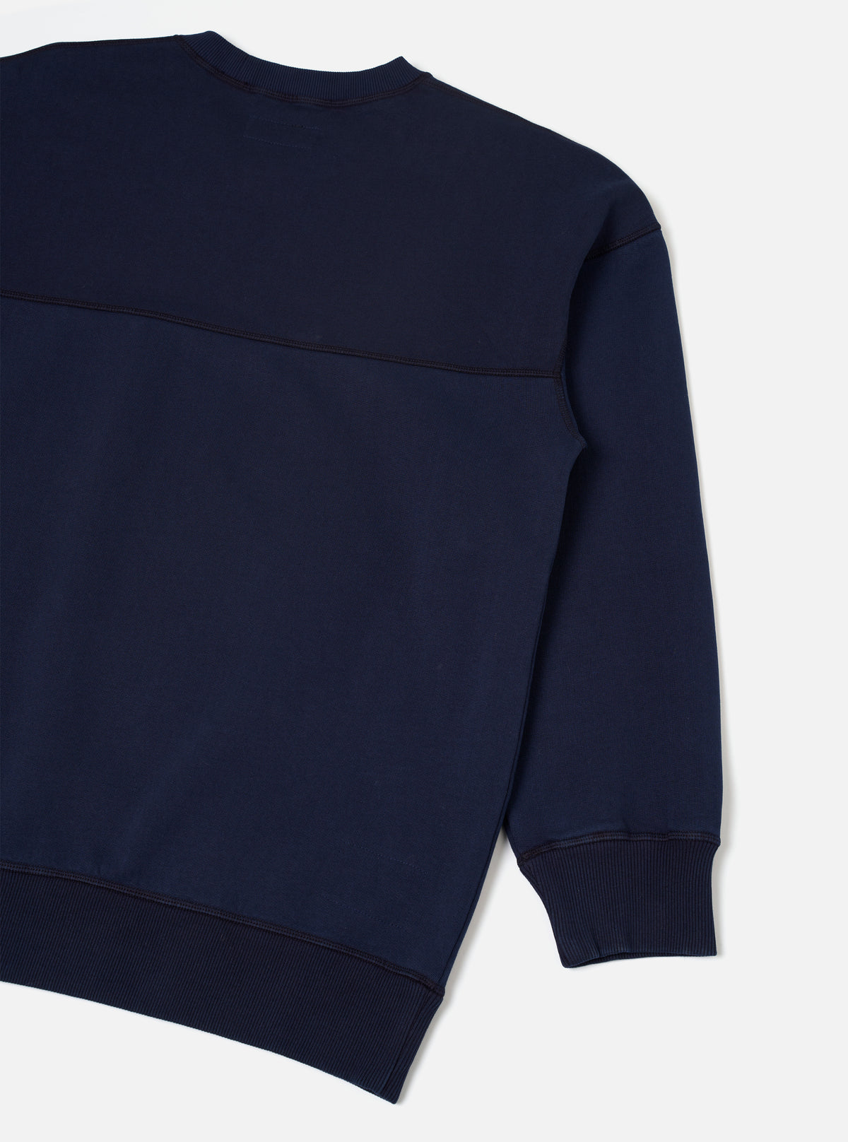 Rear view of the Walsh x Universal Works Navy Brushback Sweat Panelled Loose Sweatshirt presented on a clean white background. The shot highlights the smooth back paneling, drop-shoulder seams, and soft navy blue brushback cotton.