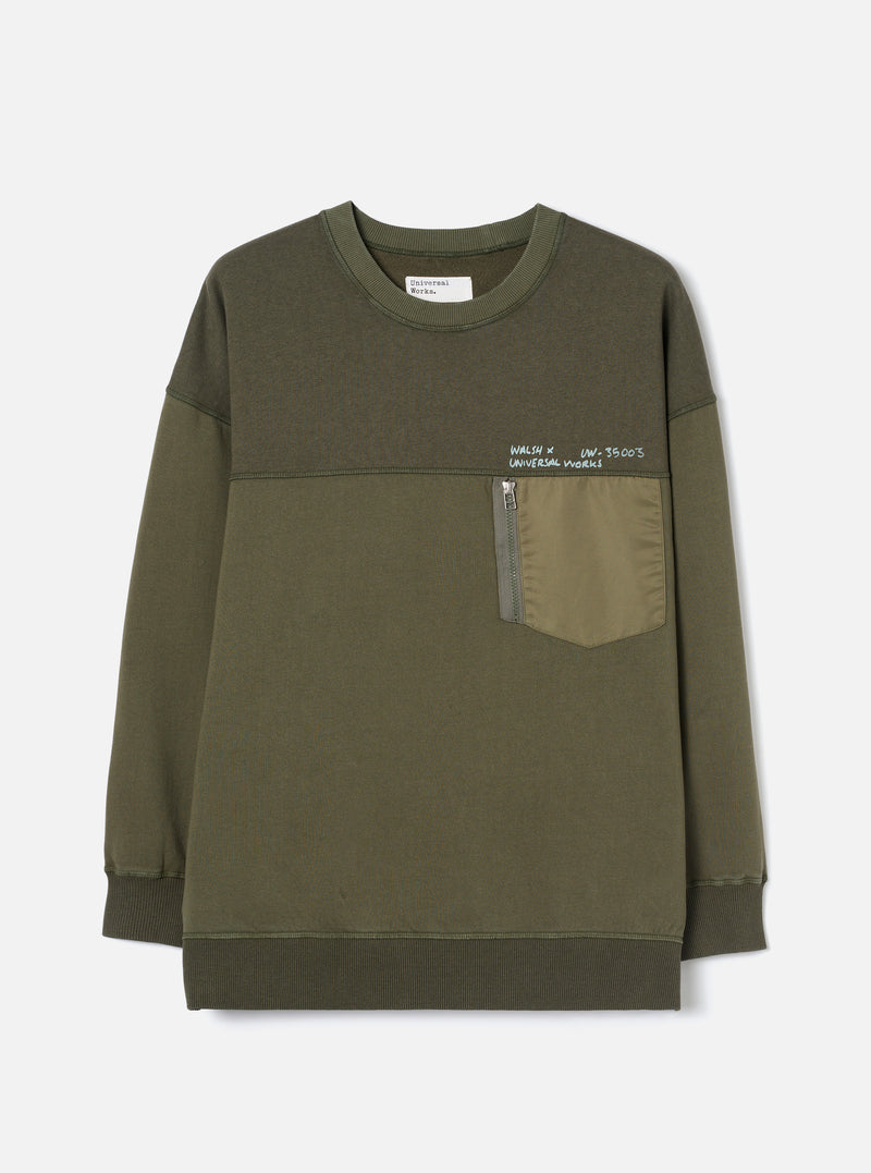 Front view of the Walsh x Universal Works Olive Brushback Sweat Panelled Loose Sweatshirt on a white background. Features include a ribbed crew neckline, panelled seam details, relaxed shoulders, and rich olive green cotton fabric.