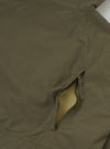 Product flat shot of the Olive WR Recycled Nylon Peak Parka displayed against a plain light background. Features include the olive green water-resistant finish, zip front, high collar, and practical flap pockets.
