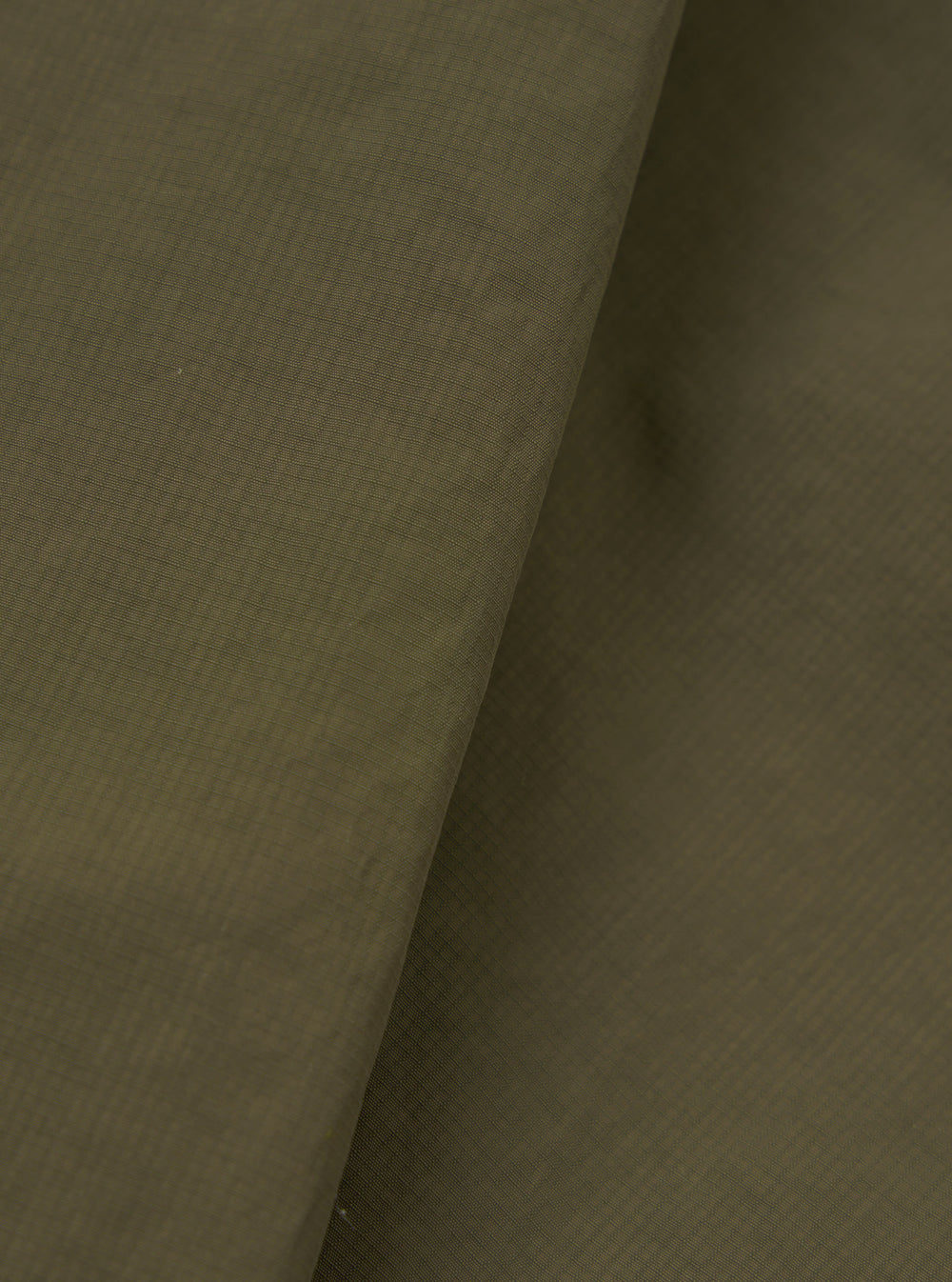 A close-up fabric swatch image of the Olive WR Recycled Nylon Peak Parka against a neutral studio background. The shot emphasizes the rich olive green colour, smooth weave, and water-resistant nylon texture.