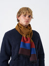A full studio product shot of the Brown Reversible Wool Himalayan Scarf displayed against a plain white background. The image highlights the rich brown tone, fringe edging, and soft woven wool texture of the accessory.