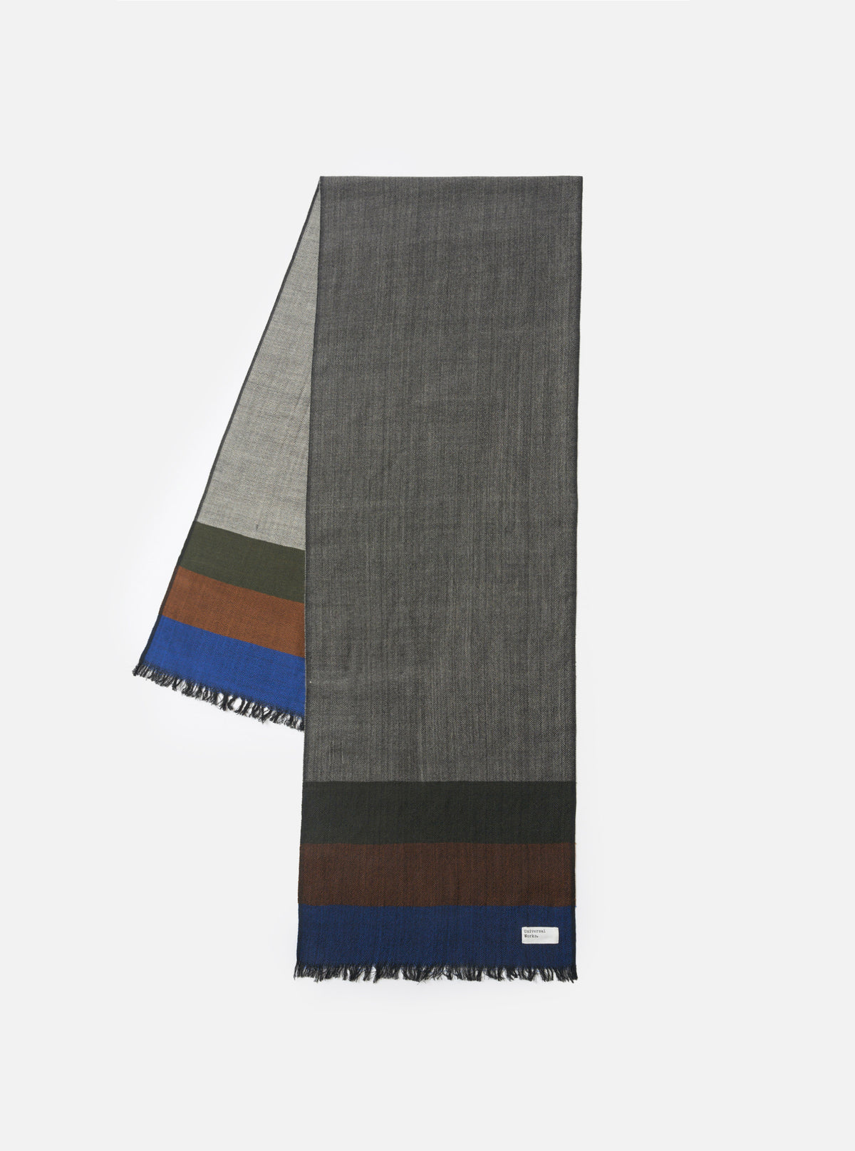 Front layout photograph of the Grey Reversible Wool Himalayan Scarf against a clean white studio background. The image prominently features the soft grey shades, woven wool composition, and fringed border.
