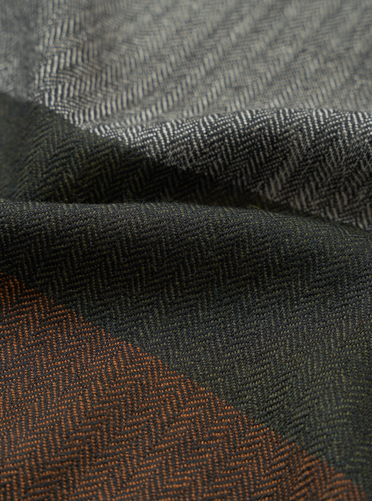Detailed fabric swatch image highlighting the Grey Reversible Wool Himalayan Scarf against a plain background. The shot captures the soft grey and charcoal thread weave, subtle heathered finish, and fine texture.