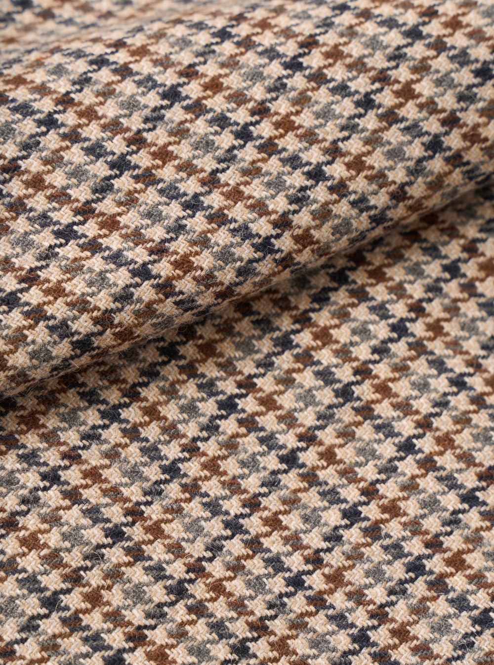 Extreme close-up swatch image of the Taupe Lester Dogtooth Franck Jacket fabric on a plain background. The shot emphasizes the intricate taupe and cream houndstooth weave and detailed textile surface texture.