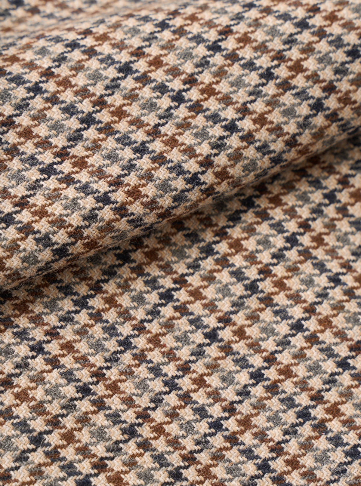 Extreme close-up swatch image of the Taupe Lester Dogtooth Franck Jacket fabric on a plain background. The shot emphasizes the intricate taupe and cream houndstooth weave and detailed textile surface texture.