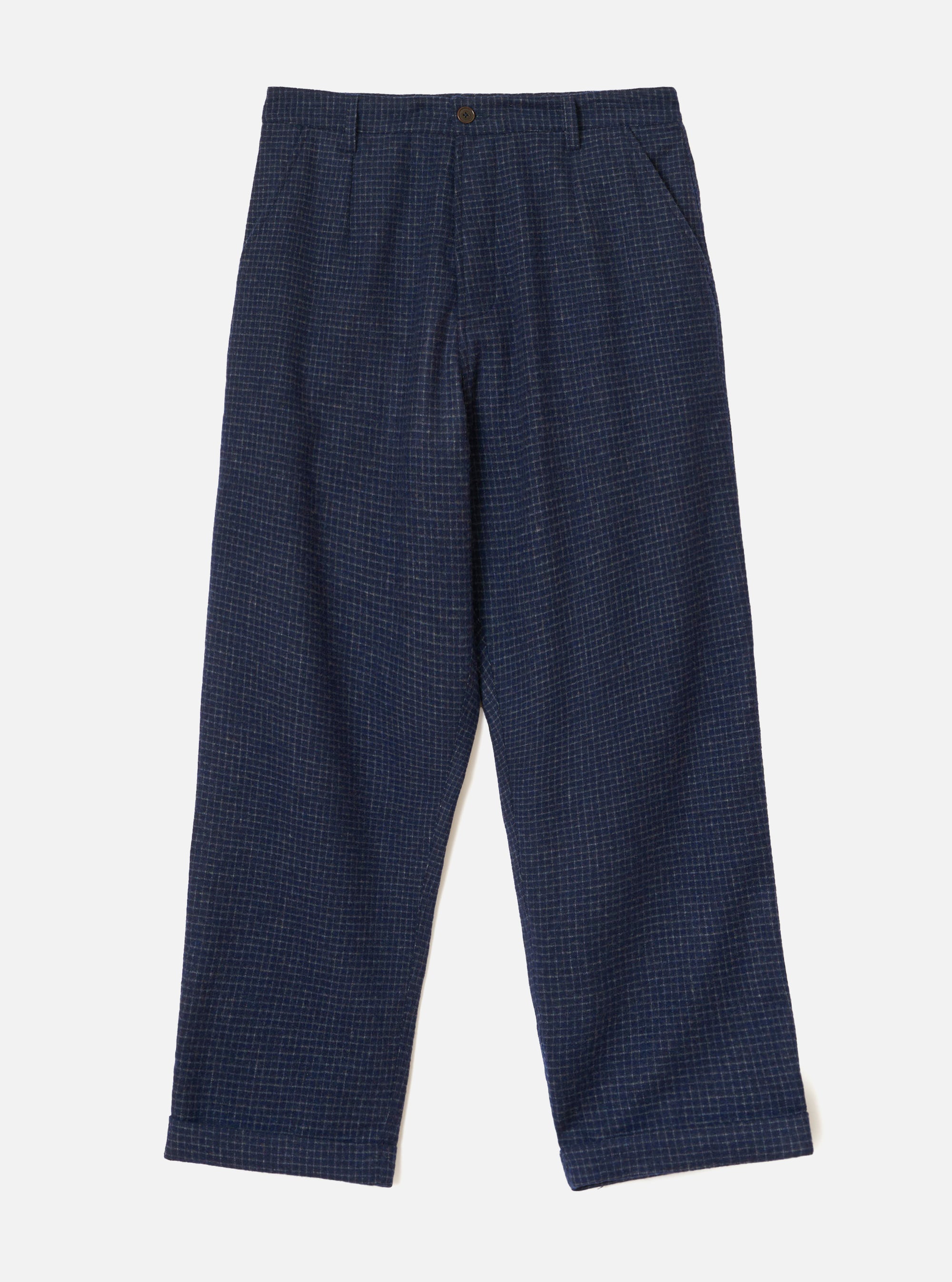 Navy check wool mix chinos laid flat on a light grey backdrop. The fabric features a fine grid check pattern in grey on navy. A single bronze button fastens the waistband, with a zip fly, front pleats, slanted side pockets, and turned-up cuffs at the full-length hem.