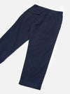 Navy check wool mix chinos laid flat on a white surface, angled diagonally. Fine light-coloured grid check on a navy ground with a textured weave. Waistband with belt loops visible, a buttoned flap pocket at the left hip, a rear welt pocket with a dark button, and an unfinished hem at the ankle.