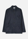 Navy wool mix bakers overshirt in a tonal check pattern, shot flat on a white studio backdrop. Features a spread collar, five dark horn-effect buttons down the centre front, one chest patch pocket, and two large lower patch pockets. Long sleeves with plain cuffs. A Universal Works woven label sits at the neck.