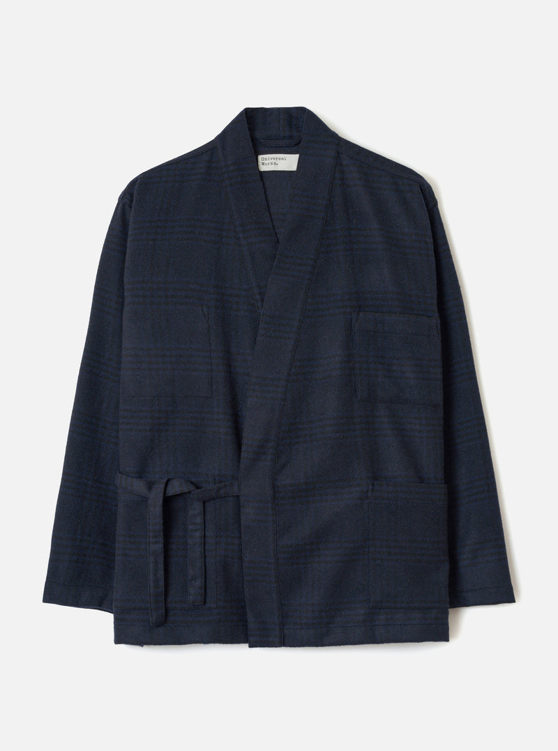 The Navy Bob Wool Mix Kyoto Work Jacket is laid flat on a light grey backdrop. Details include a tonal glen plaid pattern, open front with shawl collar, self-tie waist belt, one chest patch pocket, two hip patch pockets, and plain sleeve cuffs.
