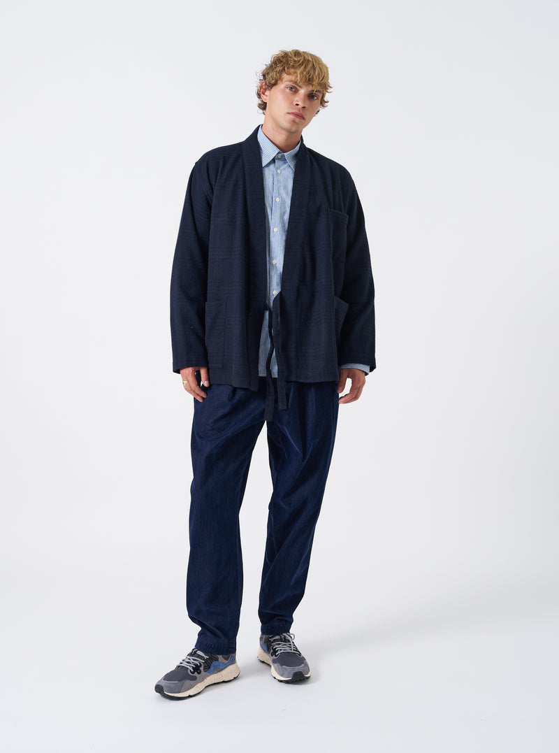 A model wearing the Navy Bob Wool Mix Kyoto Work Jacket, viewed from the front. The navy wrap-style jacket features a side tie closure, kimono-inspired collar, and deep front patch pockets against a plain background.