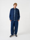 A model wearing the Indigo Contrast Stitch Work Denim Fatigue Shirt, shown from the front. The dark indigo cotton denim overshirt features prominent contrast stitching and large chest pockets against a plain backdrop.