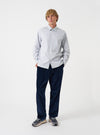 A model wearing the Grey Stripe Refab Compact Cotton Lucky Shirt, viewed from the front. The grey striped shirt displays a classic button-down collar, central placket, and single chest pocket against a plain background.